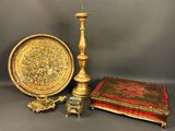 three pieces of gold and red are sitting on a table