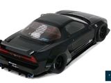 the black toy car is parked on the white surface
