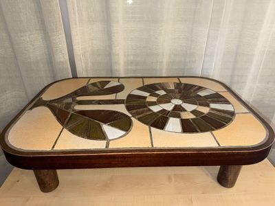 a coffee table with a mosaic design on top of it