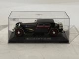 a black model of a car in a clear case