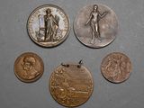 four different types of coins are shown on a gray surface