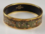 an image of a gold and green bracelet with a design on it