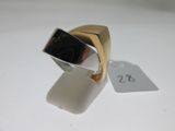 a gold ring with a black stone on it