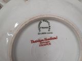 a bowl and saucer sitting on a table