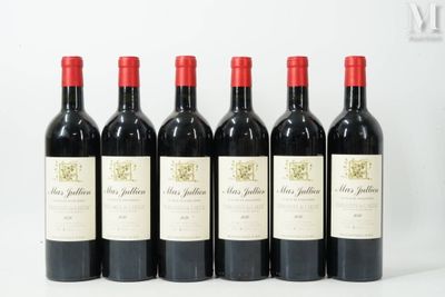 six bottles of red wine lined up in a row on a white surface