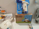 a broom, a brush, and other cleaning supplies on a counter