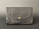 an image of a black purse with gold hardware on the front