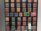 an open book with stamps on it sitting on a table