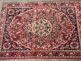 a red rug with a medallion design on top of it