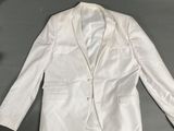 an image of a white jacket and tie on a table