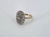 an image of a diamond and emerald ring on a white surface