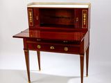 a small desk with a drawer on top of it