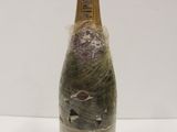 a bottle of wine that has been wrapped in plastic