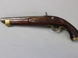 a close up of a gun on a table with a white background
