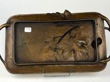 a bronze tray with a picture of a horse on it