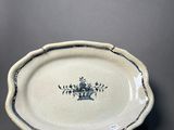 an oval platter with a blue and white design on it