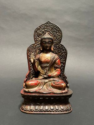 an image of a statue of a buddha sitting on a table