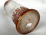 a glass cup that has a brown design on it