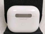 a white apple airpods sitting on top of a black stand