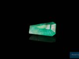 a green emerald stone on a black background