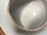 a white bowl sitting on top of a wooden table