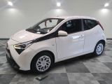 a picture of a small white car in a showroom