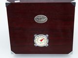 wooden box with a clock on top of it on a white surface