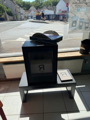 a small television sitting on a small table in front of a window