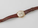 a close up of a wrist watch on a white surface