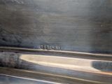 a close up of a silver plate on a table