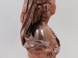 carved bust of a woman with a veil on her head