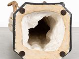 a white and black vase sitting on the floor