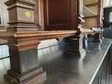 a wooden shelf with a clock on top of it