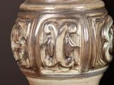 a vase that has carvings on it on a table
