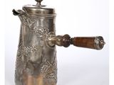a silver coffee pot with a wooden handle on a white background