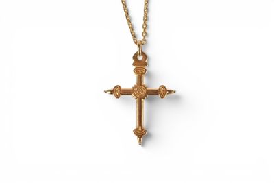 a gold cross necklace with a chain on a white background