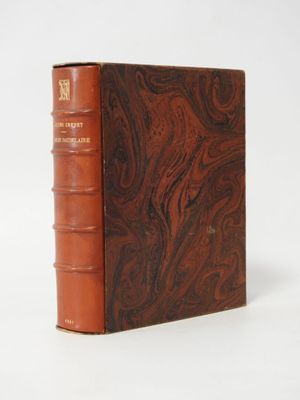 an old book sitting on top of a white table next to a white wall