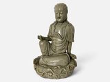 une image représentant une statue d'une personne assise sur un lotus