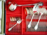 silverware in a red case with spoons, forks and spoons in it