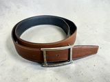 a close up of a brown leather belt with a silver buckle