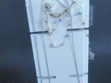 a display case with a pair of necklaces on it