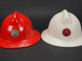two white and red fire hats sitting next to each other