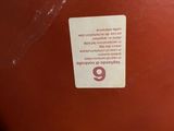 the back of a red suitcase sitting on top of a table