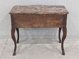 a small wooden table with a marble top on it