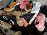 many pairs of shoes that are sitting on the floor