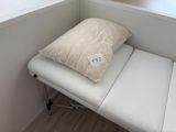 a pillow sitting on top of a bed in a room