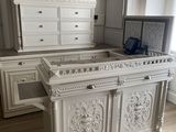 a large white bed sitting in the middle of a room