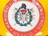 a close up of a yellow fire hydrant with a badge on it