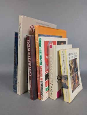 several books are stacked on top of each other on a table