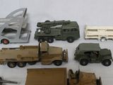 a lot of toy military vehicles and a plane on a table